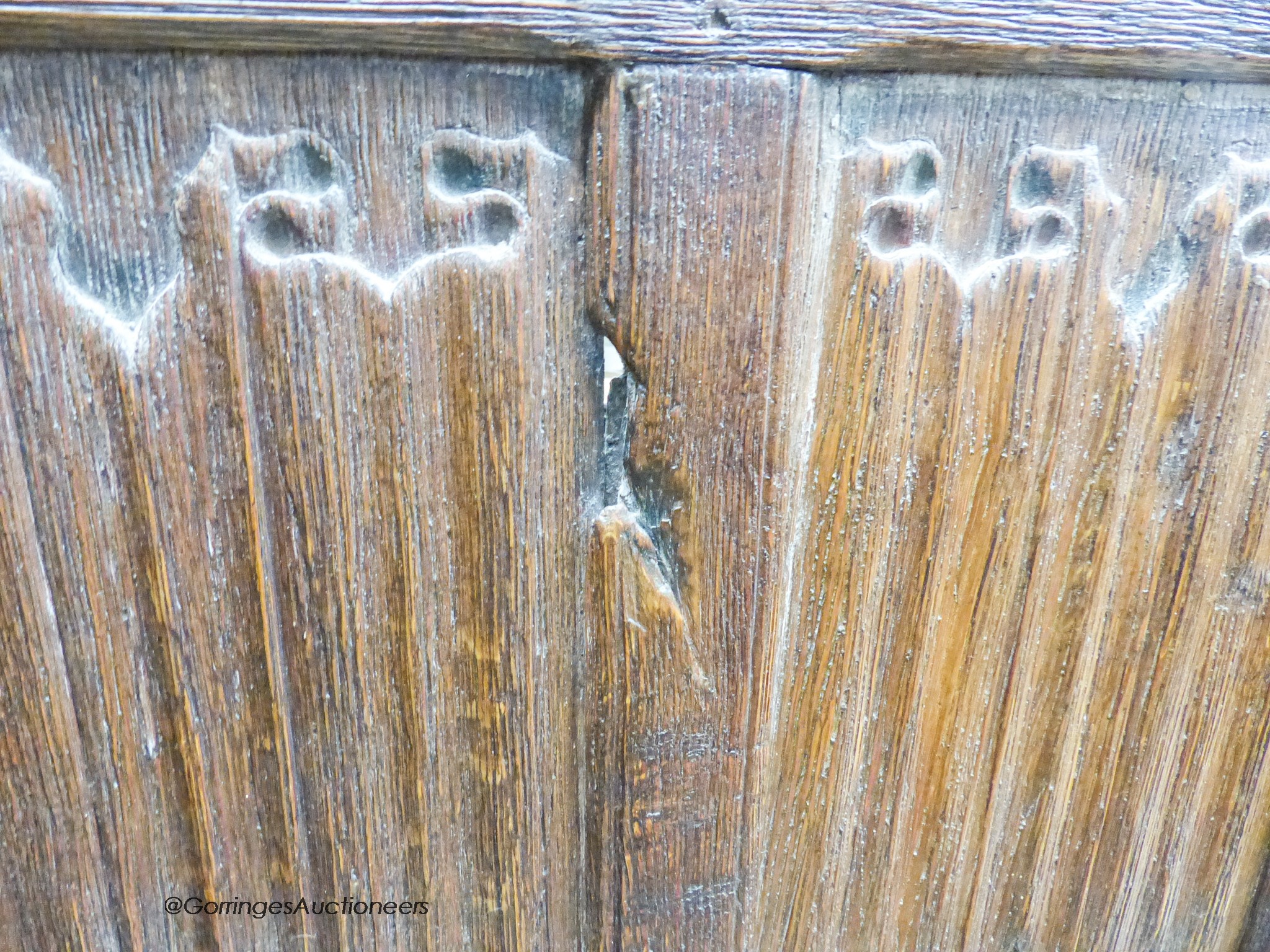 An oak three-fold screen incorporating twenty-four 16th / 17th century linenfold-carved panels, each panel width 59cm, height 182cm